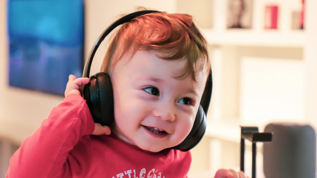Toddler with headphones in sandbox aba austin texas
